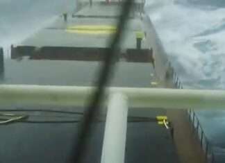  a Merchant ship struggling against the storm