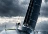 Editorial Photography Of A High-Performance Imoca 60 Offshore Racing Sailboat With Hydrofoils, Heeling And Flying Across…