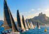 Refeno 2026: recorde de embarcações larga em busca de destronar o Adrenalina Pura Fleet of racing sailboats at the starting line of an offshore ocean regatta, dramatic wide shot, blue tropical ocean, cl…