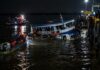 naufrágio de ferry-boat em Barcarena resgata 11 do Marajó A small passenger ferry boat partially sunk at night near a river port dock in the Amazon region of northern Brazil, dar…